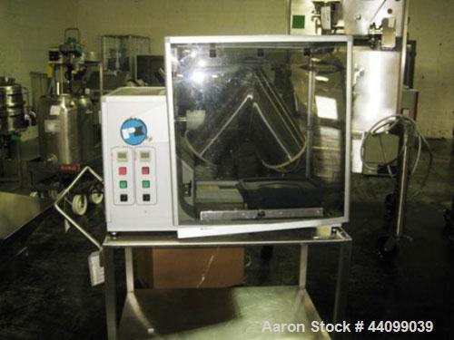 Used Patterson-Kelley Twin Shell Blender, 16 Quart, Stainless Steel. Rated 125/140 pounds a cubic foot maximum material density, with liquid feed bar, plastic enclosure with both shell and bar drives...