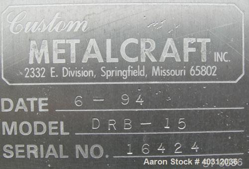 Used Custom Metalcraft Dual Shaft Paddle Mixer, 15 cubic feet, model DRB-15, 304 stainless steel. Dimpled jacketed tapered trough 39'' wide x 48'' long x 25'' deep. (10) approximately 4 1/2'' wide x ...