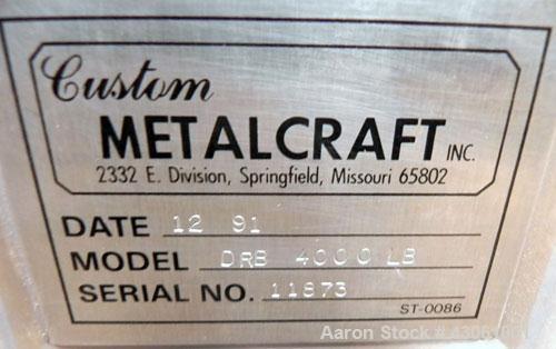 Used Custom Metalcraft Dual Shaft Paddle Mixer, 90 Cubic Feet (4000 Pounds), Model DRB-4000LB, 304 Stainless Steel. Non-jacketed trough 58-1/4" wide x 95-1/2" long x approximately 25" deep. (2) 4-1/4...