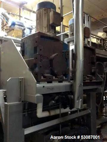 Used Karl Schnell Paddle Mixer, Stainless Steel. Approximately 140 cubic feet, 4000 Liter capacity. Has stainless steel feed hopper with dual screw conveyors, driven by (2) Approximate 5.4HP drive ge...