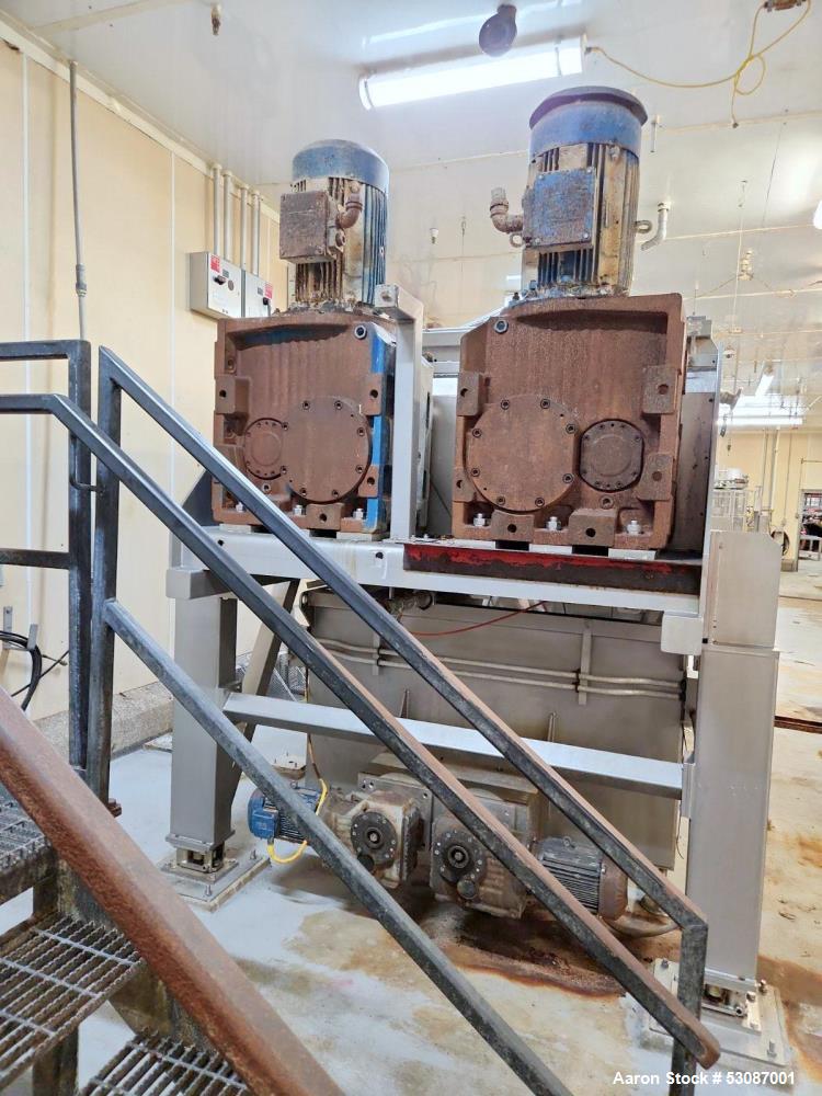 Used Karl Schnell Paddle Mixer, Stainless Steel. Approximately 140 cubic feet, 4000 Liter capacity. Has stainless steel feed hopper with dual screw conveyors, driven by (2) Approximate 5.4HP drive ge...