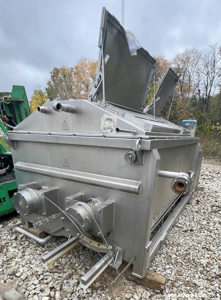Used Karl Schnell Paddle Mixer, Stainless Steel. Approximately 140 cubic feet, 4000 Liter capacity. Has stainless steel feed hopper with dual screw conveyors, driven by (2) Approximate 5.4HP drive ge...