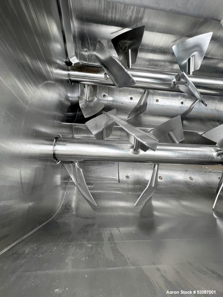 Used Karl Schnell Paddle Mixer, Stainless Steel. Approximately 140 cubic feet, 4000 Liter capacity. Has stainless steel feed hopper with dual screw conveyors, driven by (2) Approximate 5.4HP drive ge...