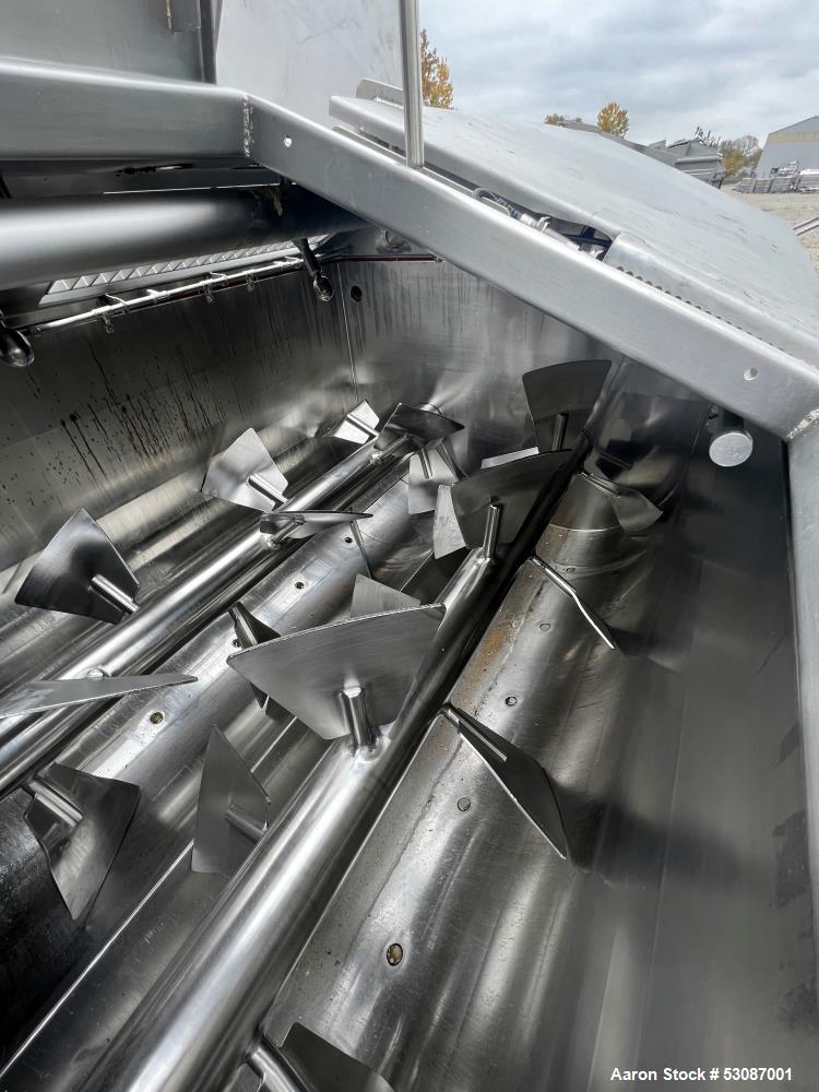 Used Karl Schnell Paddle Mixer, Stainless Steel. Approximately 140 cubic feet, 4000 Liter capacity. Has stainless steel feed hopper with dual screw conveyors, driven by (2) Approximate 5.4HP drive ge...