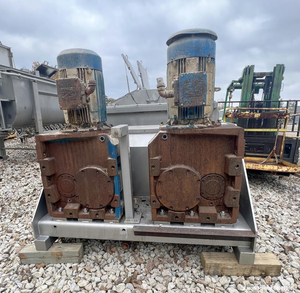 Used Karl Schnell Paddle Mixer, Stainless Steel. Approximately 140 cubic feet, 4000 Liter capacity. Has stainless steel feed hopper with dual screw conveyors, driven by (2) Approximate 5.4HP drive ge...