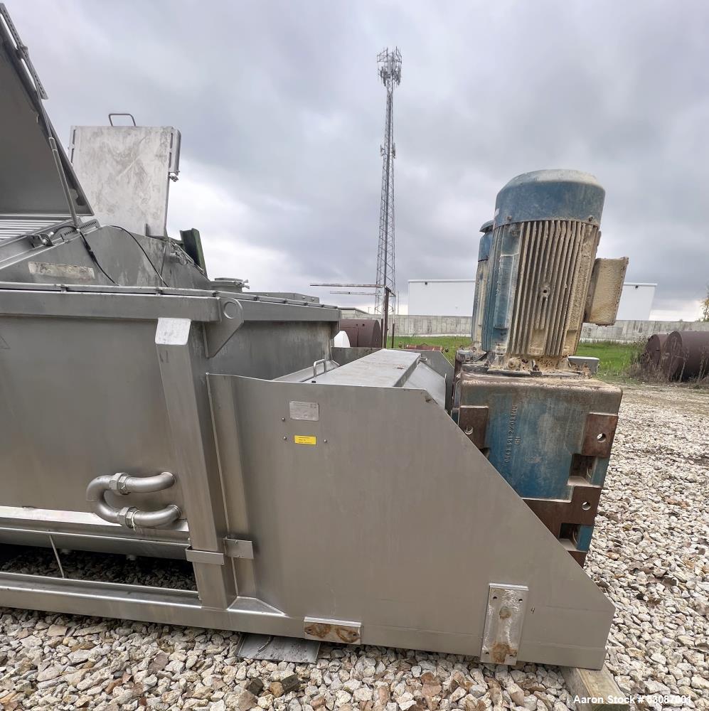 Used Karl Schnell Paddle Mixer, Stainless Steel. Approximately 140 cubic feet, 4000 Liter capacity. Has stainless steel feed hopper with dual screw conveyors, driven by (2) Approximate 5.4HP drive ge...