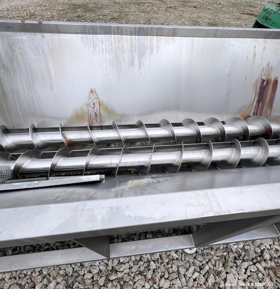 Used Karl Schnell Paddle Mixer, Stainless Steel. Approximately 140 cubic feet, 4000 Liter capacity. Has stainless steel feed hopper with dual screw conveyors, driven by (2) Approximate 5.4HP drive ge...