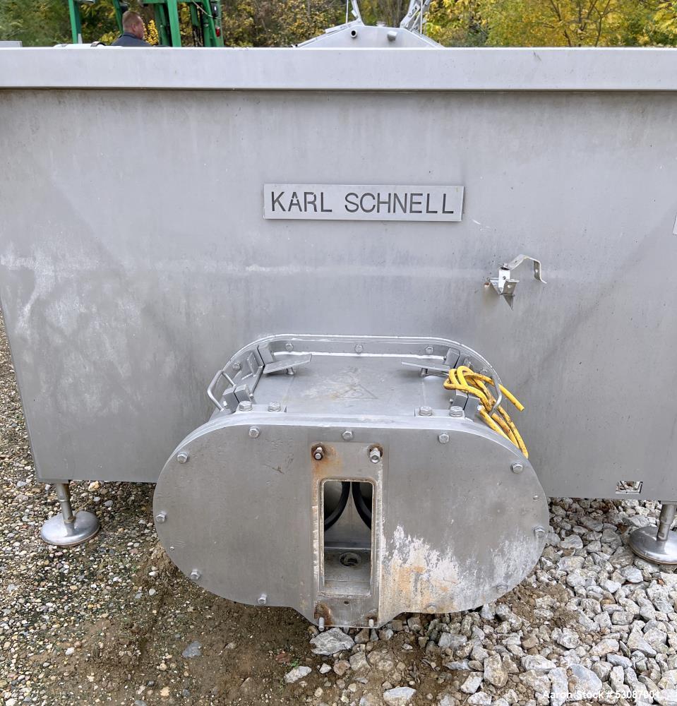 Used Karl Schnell Paddle Mixer, Stainless Steel. Approximately 140 cubic feet, 4000 Liter capacity. Has stainless steel feed hopper with dual screw conveyors, driven by (2) Approximate 5.4HP drive ge...