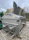 Used Karl Schnell Paddle Mixer, Stainless Steel. Approximately 140 cubic feet, 4000 Liter capacity. Has stainless steel feed hopper with dual screw conveyors, driven by (2) Approximate 5.4HP drive ge...