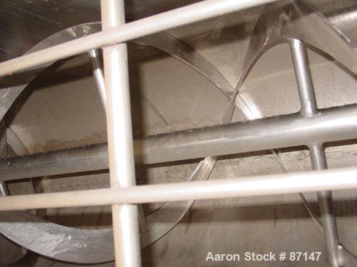 USED: Double spiral ribbon blender, 24 cubic feet working capacity, stainless steel. Non-jacketed trough 24" wide x 72" long x approximately 28" deep. 2-1/2" diameter shaft, inner ribbon 3" wide x 1/...