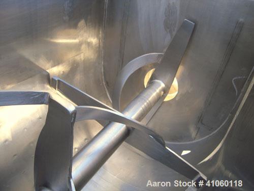Used Aaron Process Double Spiral Ribbon Blender, 14 Cubic Feet Working Capacity, 304 Stainless Steel. Dimple jacketed trough 24" wide x 48" long  x approximately 27 1/2" deep, rated 100 psi at 350 de...