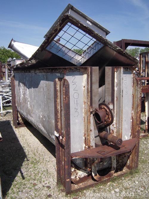 Used Ribbon Blender, 143 Cubic Feet, 304 Stainless Steel. Non-jacketed trough 44" wide x 144" long x approximately 59" deep. 4" diameter stainless steel clad shaft with partial ribbons and posts. 1 p...