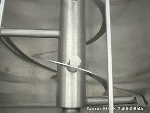 Used Double spiral ribbon blender, 267 cubic feet working capacity, 304 stainless steel. Non-jacketed trough 60" wide x 144" long x approximately 65" deep. 9 1/2" diameter shaft, inner ribbon 3" wide...