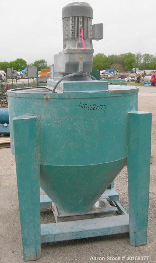 Used Universal Dynamics Vertical Ribbon Mixer, approximately 26 cubic feet, model 65-2000, carbon steel. 48" diameter x 22" straight side x 30" coned bottom. 3" diameter shaft, single ribbon 1 3/4" w...