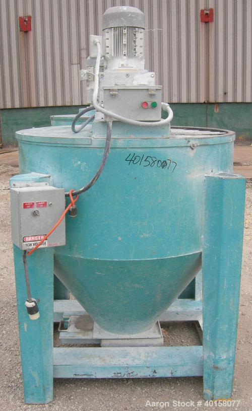 Used Universal Dynamics Vertical Ribbon Mixer, approximately 26 cubic feet, model 65-2000, carbon steel. 48" diameter x 22" straight side x 30" coned bottom. 3" diameter shaft, single ribbon 1 3/4" w...