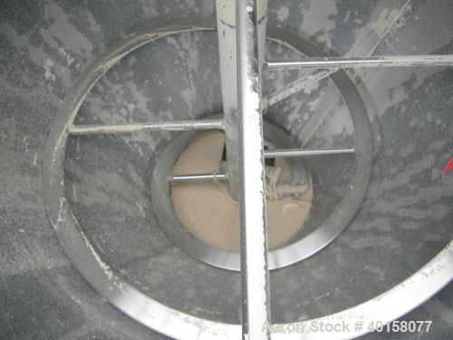 Used Universal Dynamics Vertical Ribbon Mixer, approximately 26 cubic feet, model 65-2000, carbon steel. 48" diameter x 22" straight side x 30" coned bottom. 3" diameter shaft, single ribbon 1 3/4" w...
