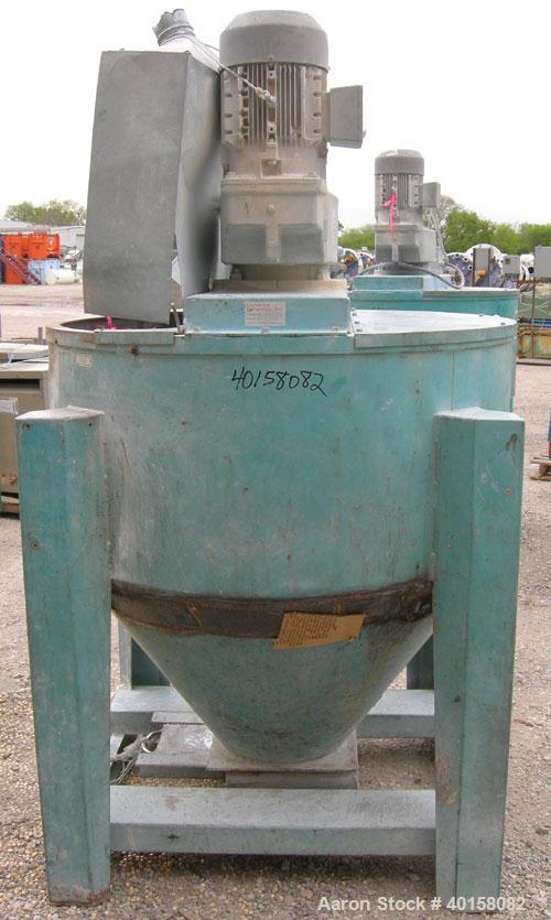 Used Universal Dynamics Vertical Ribbon Mixer, approximately 26 cubic feet, model 65-2000, carbon steel. 48" diameter x 22" straight side x 30" coned bottom. 3" diameter shaft, single ribbon 1 3/4" w...