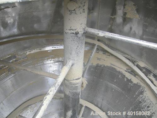 Used Universal Dynamics Vertical Ribbon Mixer, approximately 26 cubic feet, model 65-2000, carbon steel. 48" diameter x 22" straight side x 30" coned bottom. 3" diameter shaft, single ribbon 1 3/4" w...