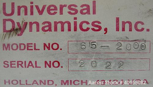 Used Universal Dynamics Vertical Ribbon Mixer, approximately 26 cubic feet, model 65-2000, carbon steel. 48" diameter x 22" straight side x 30" coned bottom. 3" diameter shaft, single ribbon 1 3/4" w...