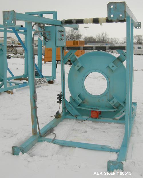 Used: Taylor Products bulk bag discharger, model DW-1000, approximate 2000 pound capacity. Includes a 54" diameter vibrating pan with bag holder, vibrating motor, and a Demag hoist with bag holder. F...