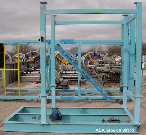 Used: Taylor Products bulk bag discharger, model DW-1000, approximate 2000 pound capacity. Includes a 54" diameter vibrating pan with bag holder, vibrating motor, and a Demag hoist with bag holder. F...