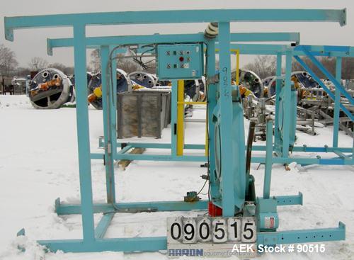 Used: Taylor Products bulk bag discharger, model DW-1000, approximate 2000 pound capacity. Includes a 54" diameter vibrating pan with bag holder, vibrating motor, and a Demag hoist with bag holder. F...