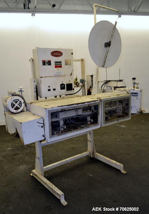 Used Doboy Model PT Pinch Bottom Bag Sealer. Up to 30 bags per minute. Designed for multiwall bags with heat-sealable inner liners. Sews bags, trims tops, applies pre-coated heat-sealable tape, and i...