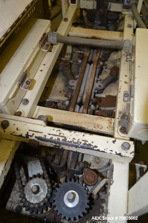 Used Doboy Model PT Pinch Bottom Bag Sealer. Up to 30 bags per minute. Designed for multiwall bags with heat-sealable inner liners. Sews bags, trims tops, applies pre-coated heat-sealable tape, and i...