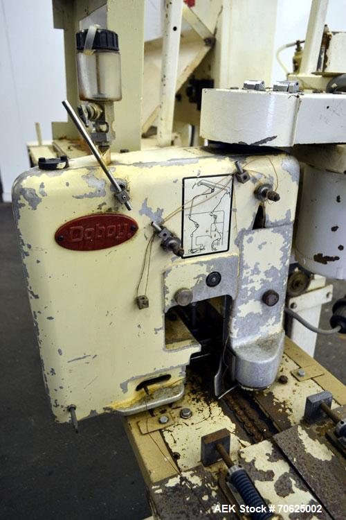 Used Doboy Model PT Pinch Bottom Bag Sealer. Up to 30 bags per minute. Designed for multiwall bags with heat-sealable inner liners. Sews bags, trims tops, applies pre-coated heat-sealable tape, and i...