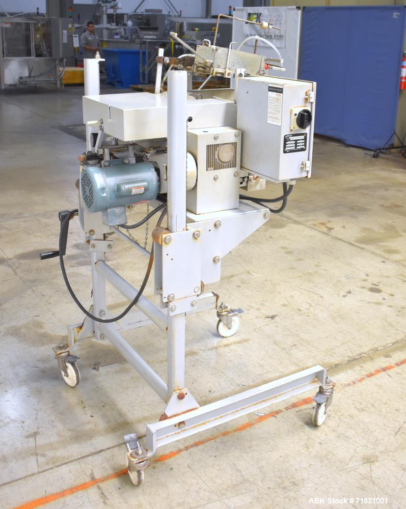 Used Bosch Doboy Semi-Automatic Bag Top Labeler, Model JSL.  Heat seals a paper header label to the top of a premade bag.  Speed up to 30 bags / minute.  Label Width: 2.5" - 9.5" (6.35 - 24.13 cm); U...