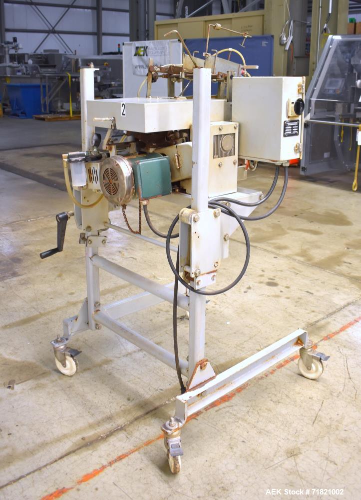 Used Bosch Doboy Semi-Automatic Bag Top Labeler, Model JSL.  Heat seals a paper header label to the top of a premade bag.  Speed Up to 30 bags / min.  Label width; 2.5" - 9.5" (6.35 - 24.13 cm), Unfo...