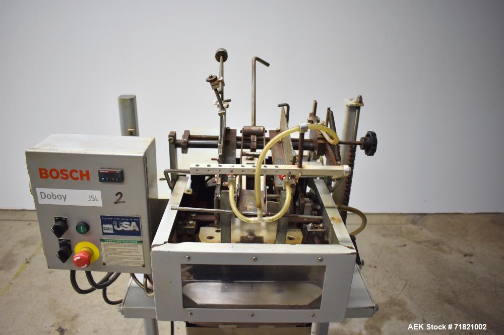Used Bosch Doboy Semi-Automatic Bag Top Labeler, Model JSL.  Heat seals a paper header label to the top of a premade bag.  Speed Up to 30 bags / min.  Label width; 2.5" - 9.5" (6.35 - 24.13 cm), Unfo...