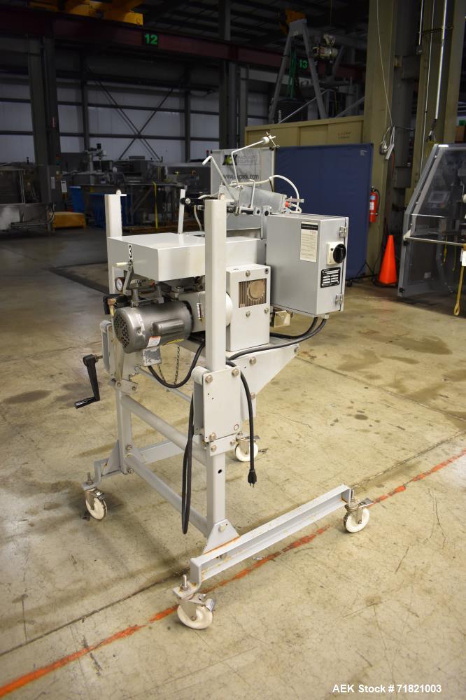 Used Bosch Doboy Semi-Automatic Bag Top Labeler, Model JSL.  Heat seals a paper header label to the top of a premade bag.  Speed Up to 30 bags / min.  Label width; 2.5" - 9.5" (6.35 - 24.13 cm), Unfo...