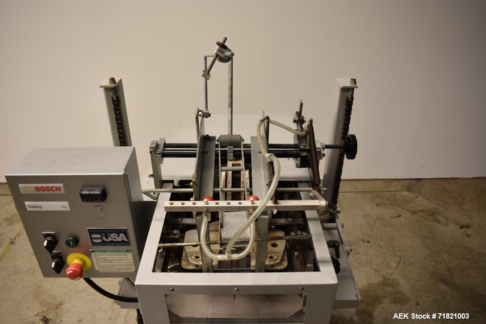 Used Bosch Doboy Semi-Automatic Bag Top Labeler, Model JSL.  Heat seals a paper header label to the top of a premade bag.  Speed Up to 30 bags / min.  Label width; 2.5" - 9.5" (6.35 - 24.13 cm), Unfo...