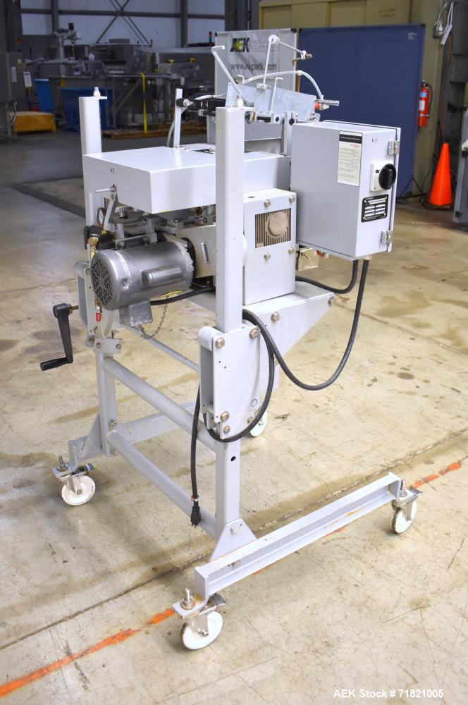 Used Bosch Doboy Semi-Automatic Bag Top Labeler, Model JSL.  Heat seals a paper header label to the top of a premade bag.  Speed Up to 30 bags / min.  Label width; 2.5" - 9.5" (6.35 - 24.13 cm), Unfo...