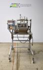 Used Bosch Doboy Semi-Automatic Bag Top Labeler, Model JSL.  Heat seals a paper header label to the top of a premade bag.  Speed up to 30 bags / minute.  Label Width: 2.5