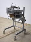 Used Bosch Doboy Semi-Automatic Bag Top Labeler, Model JSL.  Heat seals a paper header label to the top of a premade bag.  Speed Up to 30 bags / min.  Label width; 2.5
