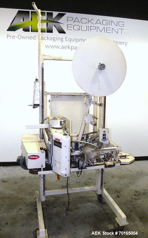 Used Doboy Model D-95A HD Bag Sewing System. Trims top of bag, folds tape over top of bag and stitches bags up to 50 linear feet per minute, can do a 1 or 2 thread stitch, and has a variable speed dr...