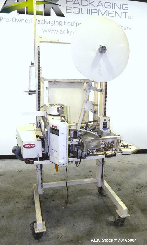 Used Doboy Model D-95A HD Bag Sewing System. Trims top of bag, folds tape over top of bag and stitches bags up to 50 linear feet per minute, can do a 1 or 2 thread stitch, and has a variable speed dr...