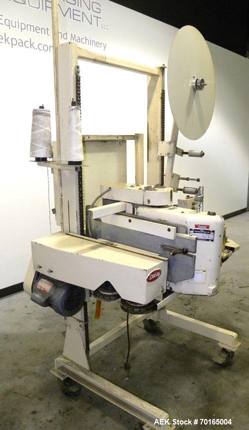 Used Doboy Model D-95A HD Bag Sewing System. Trims top of bag, folds tape over top of bag and stitches bags up to 50 linear feet per minute, can do a 1 or 2 thread stitch, and has a variable speed dr...