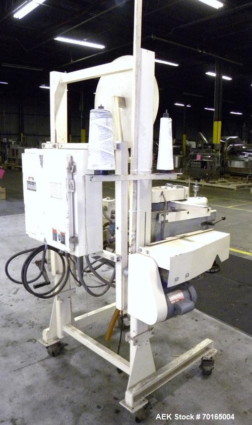 Used Doboy Model D-95A HD Bag Sewing System. Trims top of bag, folds tape over top of bag and stitches bags up to 50 linear feet per minute, can do a 1 or 2 thread stitch, and has a variable speed dr...