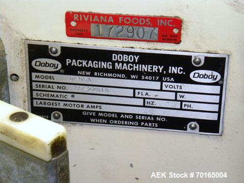 Used Doboy Model D-95A HD Bag Sewing System. Trims top of bag, folds tape over top of bag and stitches bags up to 50 linear feet per minute, can do a 1 or 2 thread stitch, and has a variable speed dr...