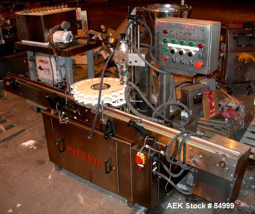 USED: Capmatic vial capper/crimper, model Patriot A10. Last doing approx 13/16" diameter caps. Includes a feed hopper, cap chute, crimping head, control panel and a 3-1/2" wide x 94" long feed/take a...