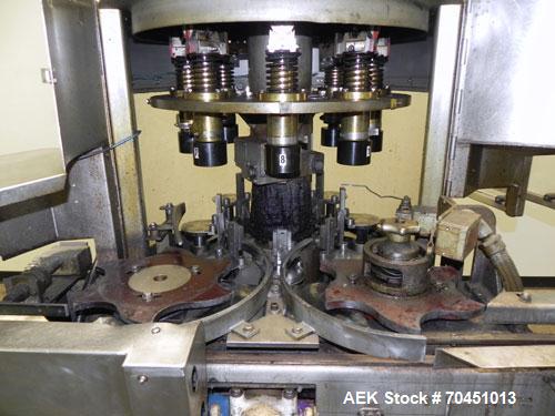Used Nalbach Model 8 H.V.C. 8-Head Rotary Cap Crimper. Machine is capable of speeds up to 240 caps per minute. Is an 8-head crimper currently set on 25mm caps. Has worm screw to star wheel infeed. Ro...