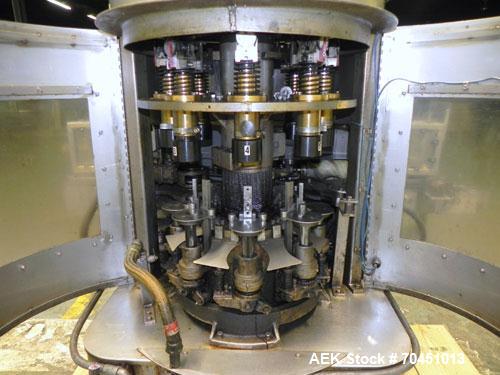Used Nalbach Model 8 H.V.C. 8-Head Rotary Cap Crimper. Machine is capable of speeds up to 240 caps per minute. Is an 8-head crimper currently set on 25mm caps. Has worm screw to star wheel infeed. Ro...