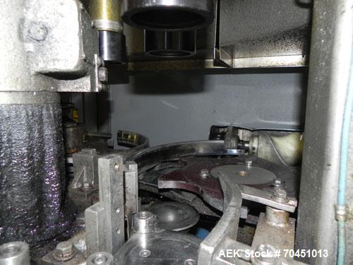 Used Nalbach Model 8 H.V.C. 8-Head Rotary Cap Crimper. Machine is capable of speeds up to 240 caps per minute. Is an 8-head crimper currently set on 25mm caps. Has worm screw to star wheel infeed. Ro...