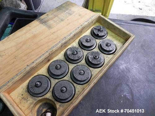 Used Nalbach Model 8 H.V.C. 8-Head Rotary Cap Crimper. Machine is capable of speeds up to 240 caps per minute. Is an 8-head crimper currently set on 25mm caps. Has worm screw to star wheel infeed. Ro...