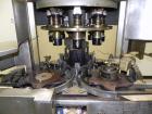 Used Nalbach Model 8 H.V.C. 8-Head Rotary Cap Crimper. Machine is capable of speeds up to 240 caps per minute. Is an 8-head crimper currently set on 25mm caps. Has worm screw to star wheel infeed. Ro...