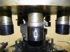 Used Nalbach Model 8 H.V.C. 8-Head Rotary Cap Crimper. Machine is capable of speeds up to 240 caps per minute. Is an 8-head crimper currently set on 25mm caps. Has worm screw to star wheel infeed. Ro...