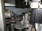 Used Nalbach Model 8 H.V.C. 8-Head Rotary Cap Crimper. Machine is capable of speeds up to 240 caps per minute. Is an 8-head crimper currently set on 25mm caps. Has worm screw to star wheel infeed. Ro...